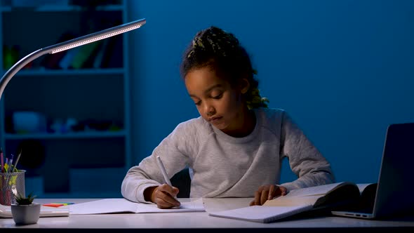 A Girl Rewrites Homework Yawns Widely Rests Her Head on Her Hands Falls Asleep