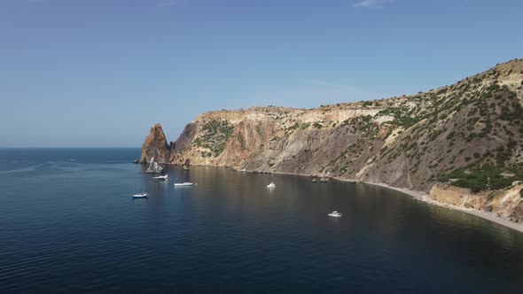 Aerial View From Above on Calm Azure Sea and Volcanic Rocky Shores