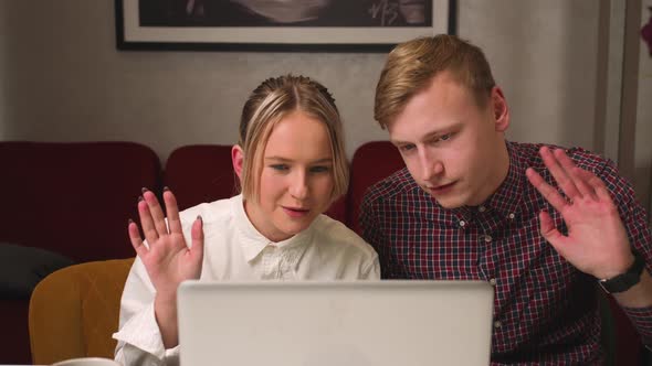 Happy Couple Has Video Call Chatting with Friends and Family on Laptop at Home