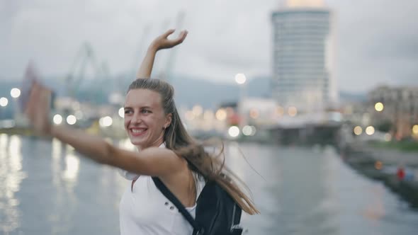 A Carefree Woman is Walking Along a City Street and Enjoying Their Youth and Free Time