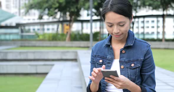 Woman use of mobile phone at outdoor 