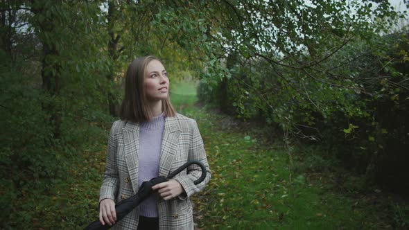 Beautiful Young Woman In Coat Walking Through Countryside