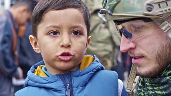 Syrian Refugee Boy Chatting with Cheerful Soldier