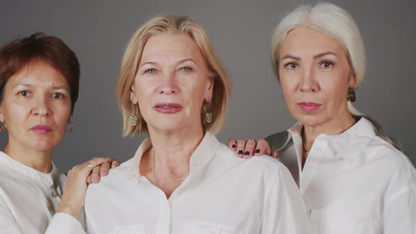 Studio Portrait of Three Mature Women Looking at Camera