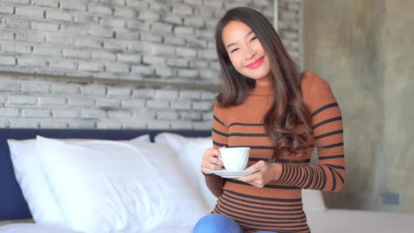 Young asian woman with coffee cup