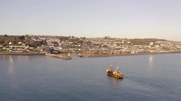 Fishing Boat Returning to Port at Sunrise