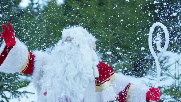 Santa Claus touching snowflakes