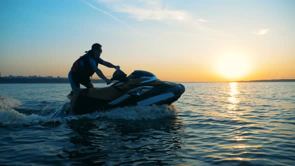 A Man Driving on a Jet Ski on Water, Close Up.