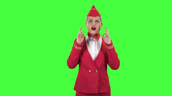 Stewardess Crossed Her Fingers. Green Screen