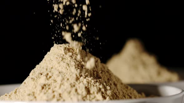 SLOW MOTION: Turmeric Powder Pouring Into A White Bowl - Close Up