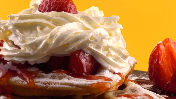 Belgian waffles with strawberry, sweet strawberry topping, whipped cream and powdered sugar.