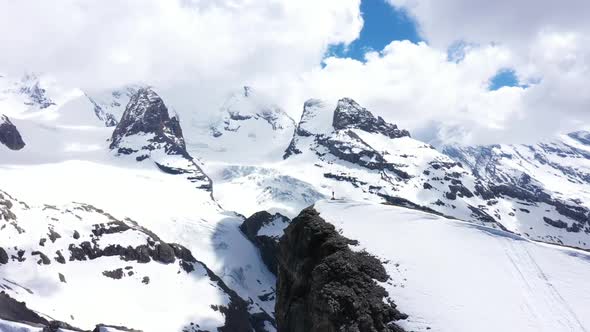 Man Standing Alone On Mountain Cliff Edge