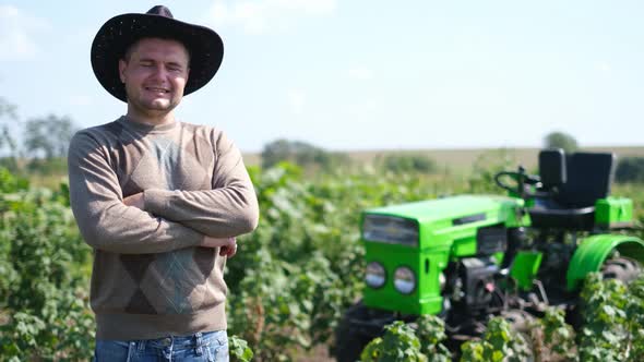 Young Attractive Man Near a Tractor