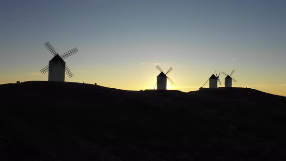 Aerial view of windmills in the countryside in Spain at sunrise