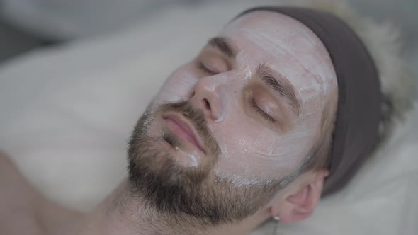 Closeup Male Face with Closed Eyes with White Purifying Cleansing Facial Cream