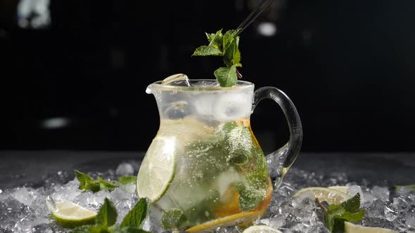 Summer Fresh Cocktail with Sparkling Water in Glass Jar with Sliced Lime Mint Leaves and Ice