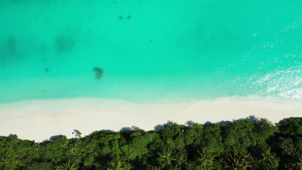 Luxury overhead abstract shot of a sandy white paradise beach and aqua turquoise water background in