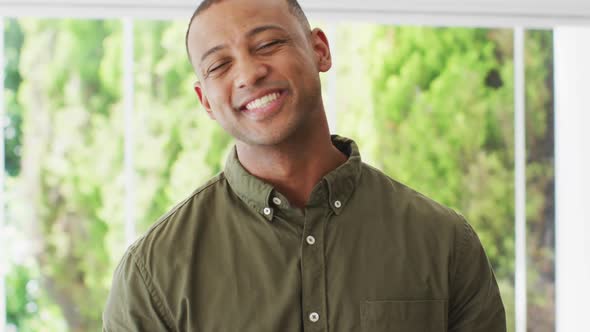 Portrait of happy biracial man looking at camera and laughing