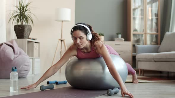 Young Caucasian Woman Exercising on Fitball