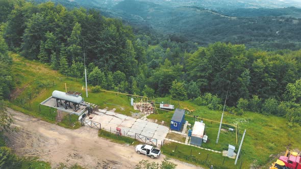 Aerial View Small Gas Station Located on Top of the Mountain. Gas Distribution Complex in the