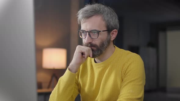 Handheld Shot of Tired Worker Yawning, Overwork on computer.Frustrated Businessman Working Alone