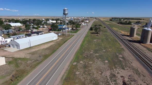 Flight towards Nunn Colorado water tower which reads watch Nunn grow.