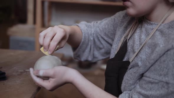 Close-up of female potter working with clay