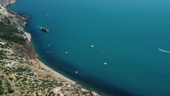 Aerial View From Above on Calm Azure Sea and Volcanic Rocky Shores