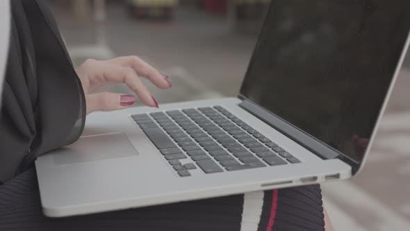 Woman Sat Outside Inputting Data Onto Her Laptop, In Slow Motion - Ungraded