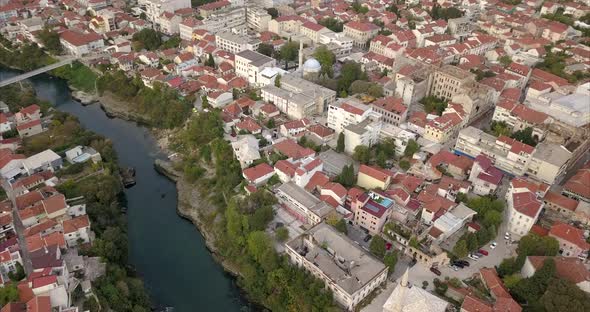 Wide angle panoramic pan of Old town Mostar and Neretva River, filmed from the air