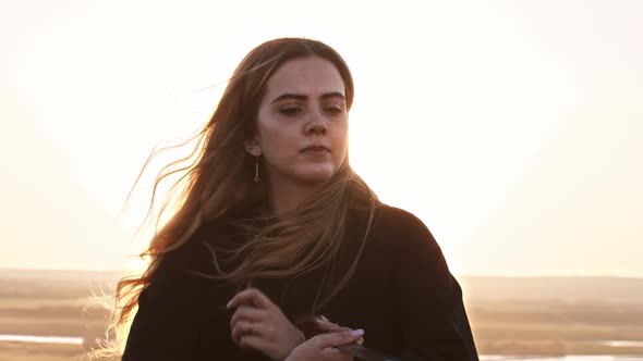 Young Pretty Woman Training with Swords on the Hill While Sunset