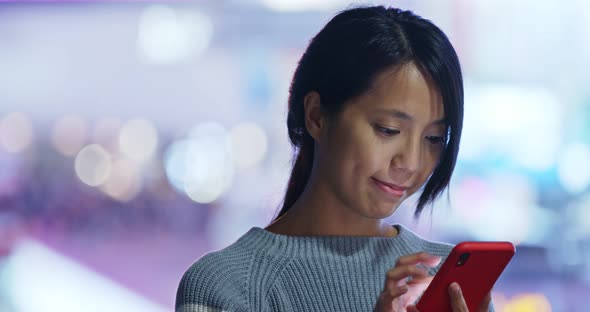 Woman use of mobile phone at night