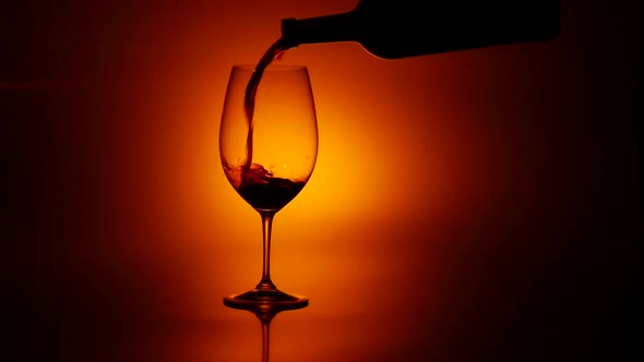 Red Wine Pouring in Glass, Dark, Slowmotion