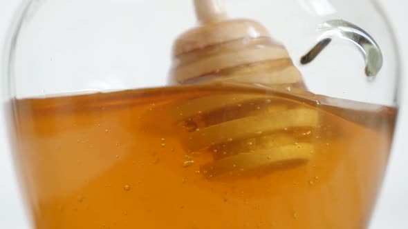 Slow motion  wooden utensil in glass honey jar 1920X1080 HD footage - Spiral dipper putting in sweet