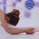 Professional Ballerina in White Tutu Is Stretching Sitting on the Floor. - VideoHive Item for Sale