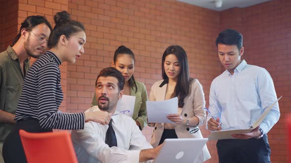 Asian young business people have meeting, brainstorming and working together as teamwork in office.