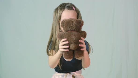 Pretty Child Girl Playing with Her Teddy Bear Toy