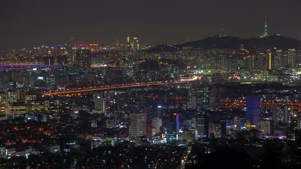 Timelapse Illuminated Buildings and Roads Against Seoul Hill