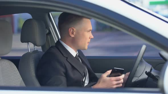 Nervous Man in Suit Sitting on Driver Seat and Calling on Phone, Late for Work