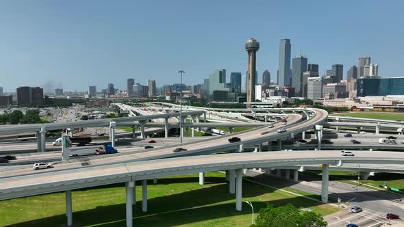 Dallas Texas skyline with traffic on interstate loop around downtown city. Aerial shot with blue sky