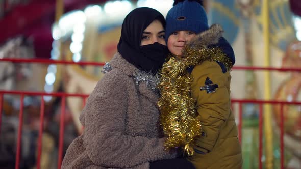 Medium Shot Portrait Positive Cute Middle Eastern Son and Young Mother in Headscarf Posing at