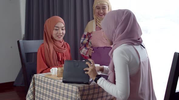 Young muslim woman use smartphone contactless payment in coffee shop