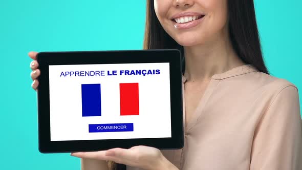 Joyful Female Holding Tablet With Learn French Language Test, Educational App