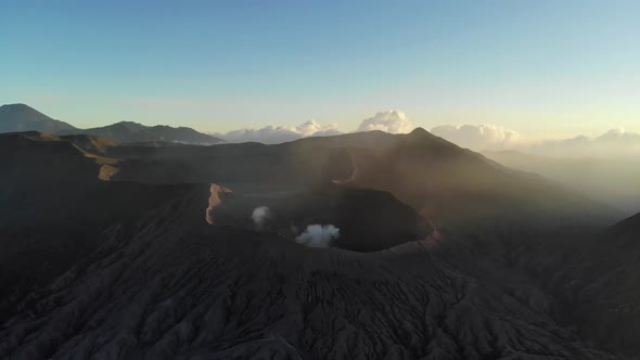 Cinematic aerial view video clip of the crater of mountain Bromo at sunrise in the morning