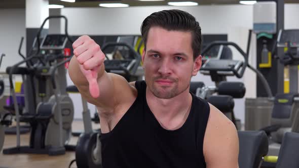 A Young Fit Man Shakes His Head at the Camera in a Gym - Closeup