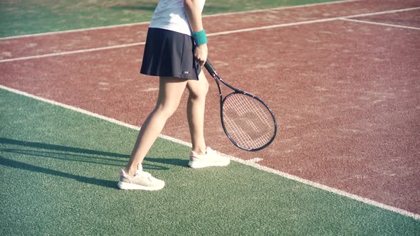 Female Tennis Player Preparing To Set Ready To Serve Ball. Girl With Rocket Playing On Tennis Court.