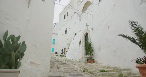 narrow street with white houses in the European old town, steps