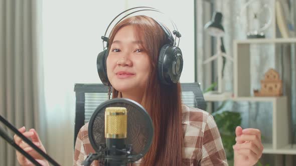 Over Shoulder View, Young Asian Woman In Headphones Singing While Recording Podcast With Male