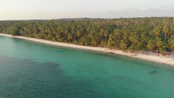 Aerial: uncontaminated white sand beach sunset at Kei Islands Maluku Indonesia