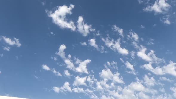 White Clouds Flying On Blue Sky With Sun Rays
